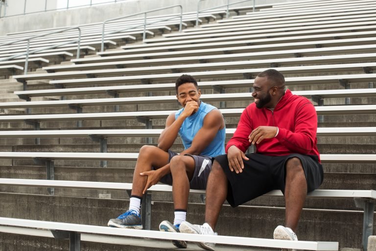 Coach spending time mentoring a student athlete.